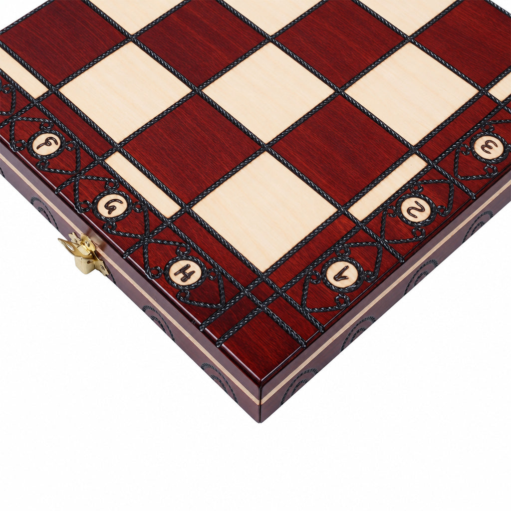 Close-up of the board corner with ornate border, round notation inlays and brass clasp